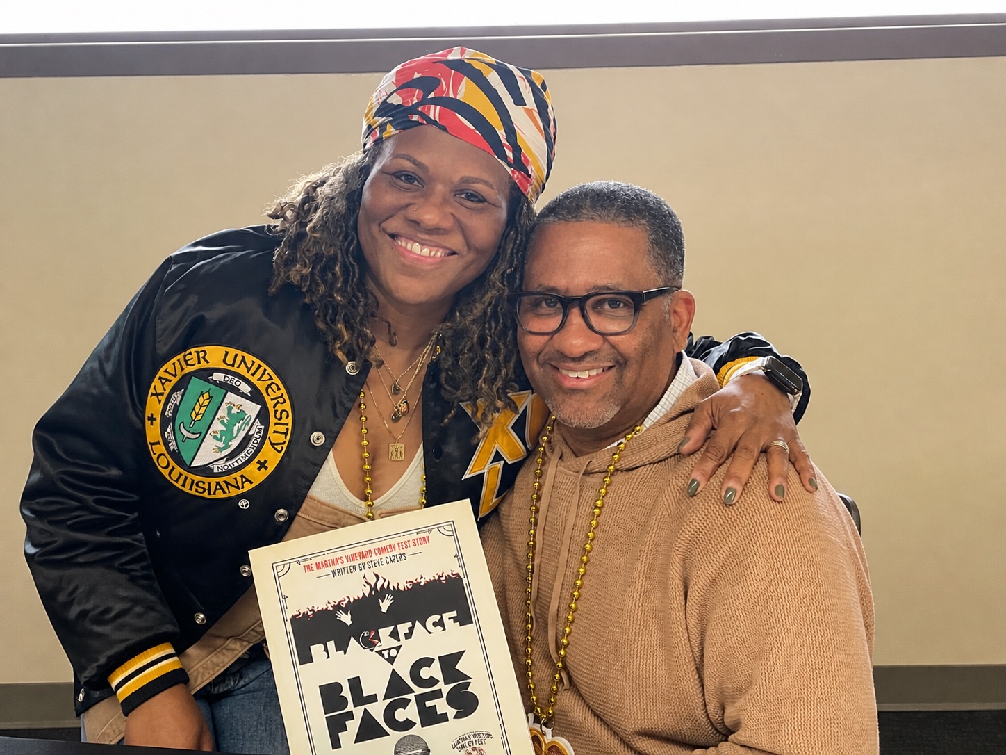 Guests holding a book during a Green Book Comedy Tour book signing.