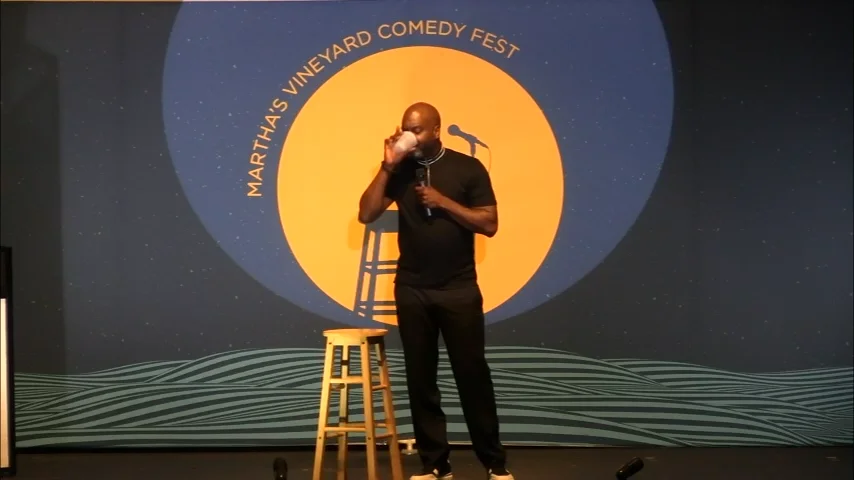 JJ performing stand-up comedy on stage at Martha's Vineyard Comedy Fest.